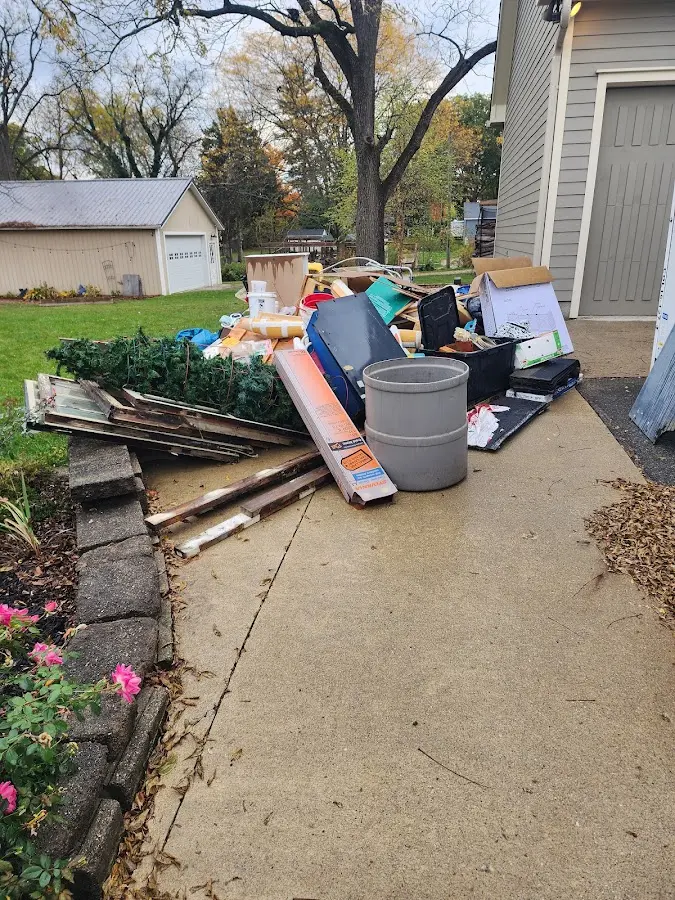 Dumpster being loaded with debris for Residential Dumpster Rental in St. James City
